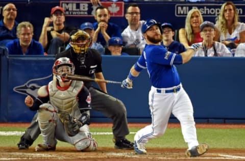 Oct 19, 2016; Toronto, Ontario, CAN; Toronto Blue Jays catcher Russell Martin (55) hits a single during the fifth inning against the Cleveland Indians in game five of the 2016 ALCS playoff baseball series at Rogers Centre. Mandatory Credit: Dan Hamilton-USA TODAY Sports