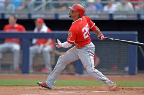 Mar 22, 2017; Peoria, AZ, USA; Los Angeles Angels center fielder Ben Revere (25) hits a three run home run during the second inning against the Seattle Mariners at Peoria Stadium. Mandatory Credit: Jake Roth-USA TODAY Sports