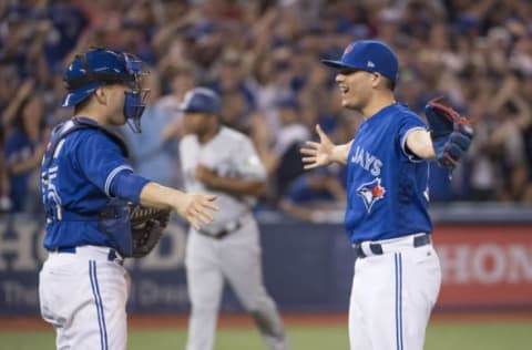 May 27, 2017; Toronto, Ontario, CAN; Toronto Blue Jays relief pitcher Roberto Osuna (right) celebrates a win with catcher Russell Martin (55) after defeating the Texas Rangers at Rogers Centre. Mandatory Credit: Nick Turchiaro-USA TODAY Sports