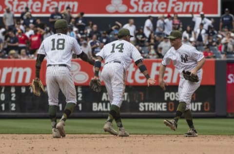 May 28, 2017; Bronx, NY, USA; New York Yankees shortstop Didi Gregorius (18) and New York Yankees second baseman Sterlin Castro (14) greet New York Yankees left fielder Brett Gardner (11) after the game against the Oakland Athletics at Yankee Stadium. Mandatory Credit: Gregory J. Fisher-USA TODAY Sports