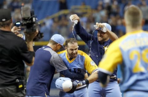 Jun 10, 2017; St. Petersburg, FL, USA; Tampa Bay Rays third baseman Evan Longoria (3) is congratulated and doused with water after hit the game winning walk off during the tenth inning against the Oakland Athletics at Tropicana Field. Mandatory Credit: Kim Klement-USA TODAY Sports