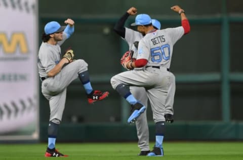 Jun 18, 2017; Houston, TX, USA; Boston Red Sox right fielder Mookie Betts (50) and left fielder Andrew Benintendi (16), and center fielder Jackie Bradley Jr. (19) dance in celebration of their win over the Houston Astros during the ninth inning at Minute Maid Park. Mandatory Credit: Shanna Lockwood-USA TODAY Sports