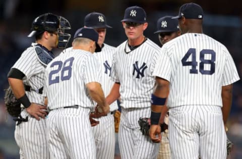 Jun 21, 2017; Bronx, NY, USA; New York Yankees relief pitcher Tyler Clippard (29) hands the ball to New York Yankees manager Joe Girardi (28) during the ninth inning against the Los Angeles Angels at Yankee Stadium. Mandatory Credit: Brad Penner-USA TODAY Sports