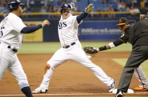 Jun 23, 2017; St. Petersburg, FL, USA; Tampa Bay Rays first baseman Logan Morrison (7) slides safe into third base with a triple as Baltimore Orioles third baseman Manny Machado (13) attempts to tag him during the first inning at Tropicana Field. Mandatory Credit: Kim Klement-USA TODAY Sports