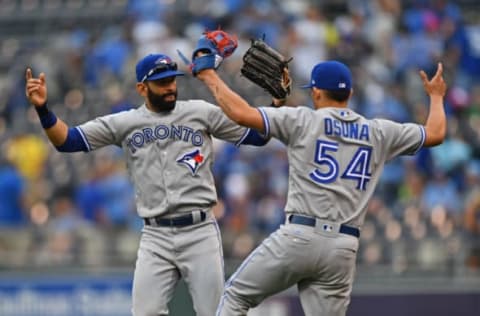 Jun 25, 2017; Kansas City, MO, USA; Toronto Blue Jays right fielder Jose Bautista (19) celebrates with teammate Roberto Osuna (54) after beating the Kansas City Royals at Kauffman Stadium. Mandatory Credit: Peter G. Aiken-USA TODAY Sports