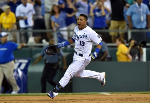 Sep 30, 2014; Kansas City, MO, USA; Kansas City Royals catcher Salvador Perez (13) reacts after hitting a walk-off single against the Oakland Athletics during the twelfth inning of the 2014 American League Wild Card playoff baseball game at Kauffman Stadium. The Royals won 9-8. Mandatory Credit: Peter G. Aiken-USA TODAY Sports