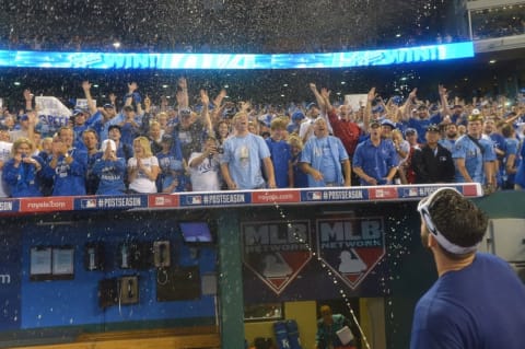 Sep 30, 2014; Kansas City, MO, USA; Kansas City Royals third baseman Mike Moustakas (8) sprays champagne toward fans after the 2014 American League Wild Card playoff baseball game against the Oakland Athletics at Kauffman Stadium. The Royals won 9-8. Mandatory Credit: Denny Medley-USA TODAY Sports