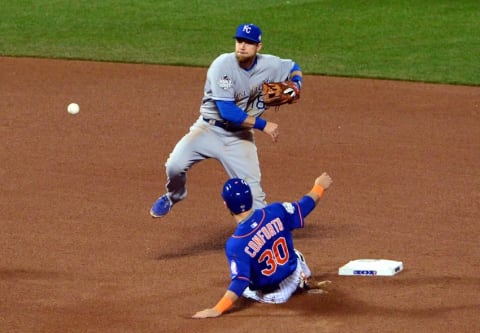 Nov 1, 2015; New York City, NY, USA; Kansas City Royals second baseman Ben Zobrist (18) turns a double play over New York Mets left fielder Michael Conforto (30) in the 7th inning in game five of the World Series at Citi Field. Mandatory Credit: Jeff Curry-USA TODAY Sports