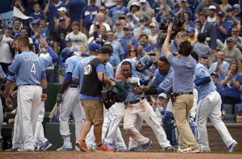 Apr 10, 2016; Kansas City, MO, USA; Kansas City Royals pinch runner Terrance Gore (0) is congratulated by the team after scoring from third base on a wild pitch by the Minnesota Twins in the tenth inning at Kauffman Stadium. Mandatory Credit: John Rieger-USA TODAY Sports