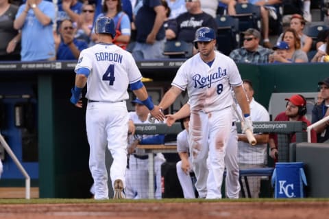 Jun 7, 2014; Kansas City, MO, USA; Kansas City Royals left fielder Alex Gordon (4) is congratulated by third baseman Mike Moustakas (8) after Gordon scores in the second inning against the New York Yankees at Kauffman Stadium. Mandatory Credit: Denny Medley-USA TODAY Sports