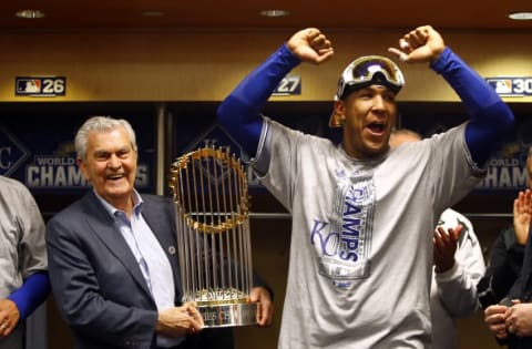 Nov 1, 2015; New York City, NY, USA; Kansas City Royals catcher Salvador Perez (right) and owner David Glass celebrate with the Commissioners Trophy after defeating the New York Mets in game five of the World Series at Citi Field. The Royals won the World Series four games to one. Mandatory Credit: Al Bello/Pool Photo via USA TODAY Sports