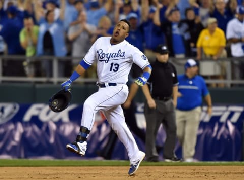 Sep 30, 2014; Kansas City, MO, USA; Kansas City Royals catcher Salvador Perez (13) reacts after hitting a walk-off single against the Oakland Athletics during the twelfth inning of the 2014 American League Wild Card playoff baseball game at Kauffman Stadium. The Royals won 9-8. Mandatory Credit: Peter G. Aiken-USA TODAY Sports