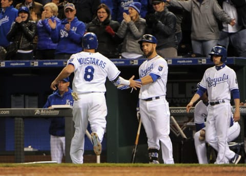 Apr 20, 2015; Kansas City, MO, USA; Kansas City Royals third baseman Mike Moustakas (8) is congratulated by left fielder Alex Gordon (4) after scoring against the Minnesota Twins in the eighth inning at Kauffman Stadium. Kansas City won the game 7-1. Mandatory Credit: John Rieger-USA TODAY Sports