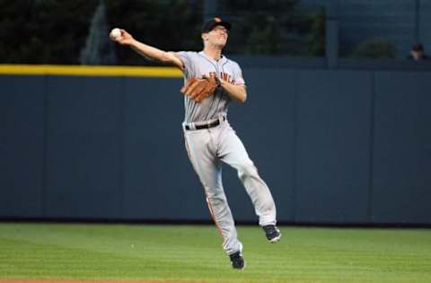 DENVER, CO – SEPTEMBER 7: Kelby Tomlinson #27 of the San Francisco Giants throws to first base in the first inning against the Colorado Rockies at Coors Field on September 7, 2016 in Denver, Colorado. Colorado Rockies defeat the San Francisco Giants 6-5.(Photo by Bart Young/Getty Images)