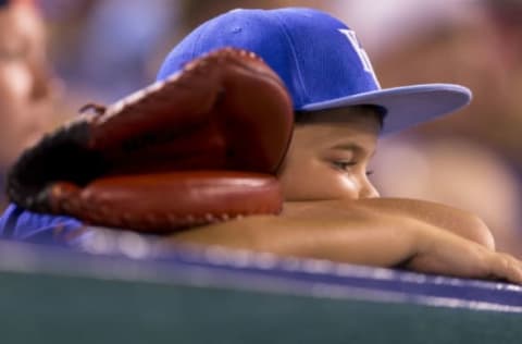 KANSAS CITY, MO – JULY 1: A child rests his head while watching the Kansas City Royals take on the Minnesota Twins during game two of a doubleheader at Kauffman Stadium on July 1, 2017 in Kansas City, Missouri. (Photo by Kyle Rivas/Getty Images)