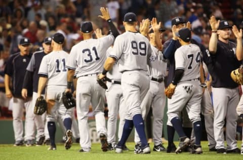 BOSTON, MA – AUGUST 19: The New York Yankees high five each other after the victory over the Boston Red Sox at Fenway Park on August 19, 2017 in Boston, Massachusetts. (Photo by Adam Glanzman/Getty Images)