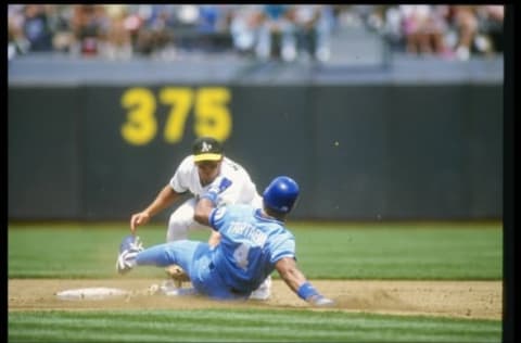 1990: Shortstop Walt Weiss of the Oakland Athletics tags Danny Tartabull of the Kansas City Royals. Mandatory Credit: Otto Greule /Allsport