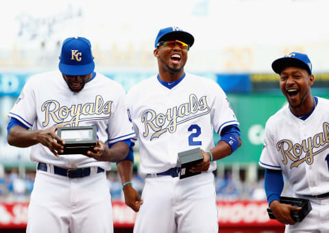 KANSAS CITY, MISSOURI – APRIL 05: Lorenzo Cain #6, Alcides Escobar #2, and Jarrod Dyson #1 of the Kansas City Royals laugh as they inspect their 2015 World Series Championship rings during a ring ceremony prior to the game between the Royals and the New York Mets at Kauffman Stadium on April 5, 2016 in Kansas City, Missouri. (Photo by Jamie Squire/Getty Images)