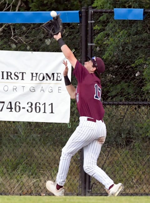 HYANNIS 06/21/21 Dylan Beavers of Cotuit makes a catch at the wall on a ball hit by #25 of Hyannis. Cape LeagueHyannis Cotuit Cape League