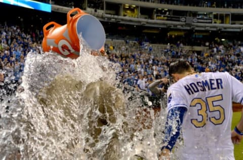 May 5, 2017; Kansas City, MO, USA; Fox Sports announcer Joel Goldberg (left) and Kansas City Royals first baseman Eric Hosmer (35) are doused by catcher Salvador Perez (13) after a win over the Cleveland Indians at Kauffman Stadium. The Royals won 3-1. Mandatory Credit: Denny Medley-USA TODAY Sports