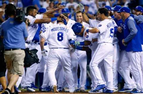 Jun 6, 2017; Kansas City, MO, USA; Kansas City Royals third baseman Mike Moustakas (8) is congratulated by teammates after hitting a walk-off home run against the Houston Astros at Kauffman Stadium. The Royals won 9-7. Mandatory Credit: Jay Biggerstaff-USA TODAY Sports