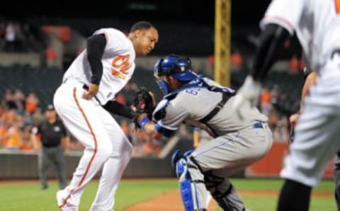 Jun 6, 2016; Baltimore, MD, USA; Baltimore Orioles second baseman Jonathan Schoop (6) is tagged out by Kansas City Royals catcher Drew Butera (9) in the seventh inning at Oriole Park at Camden Yards. The Baltimore Orioles won 4-1. Mandatory Credit: Evan Habeeb-USA TODAY Sports