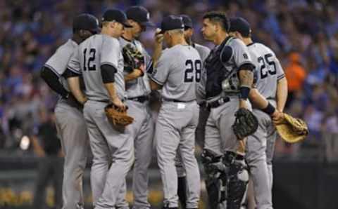 Aug 31, 2016; Kansas City, MO, USA; New York Yankees manager Joe Girardi (28) talks with his infield on the mound against the Kansas City Royals during the seventh inning at Kauffman Stadium. Mandatory Credit: Peter G. Aiken-USA TODAY Sports