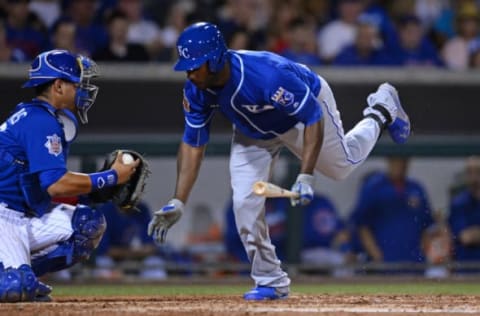 Mar 19, 2017; Mesa, AZ, USA; Kansas City Royals center fielder Lorenzo Cain (6) stumbles after avoiding a pitch against the Chicago Cubs during the third inning at Sloan Park. Mandatory Credit: Joe Camporeale-USA TODAY Sports