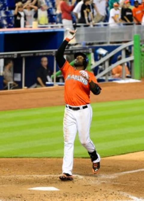 Miami Marlins center fielder Marcell Ozuna (13) presumably points to Jeff Loria after hitting a solo home run off of Milwaukee Brewers relief pitcher Francisco Rodriguez during the ninth inning at Marlins Ballpark. Mandatory Credit: Steve Mitchell-USA TODAY Sports