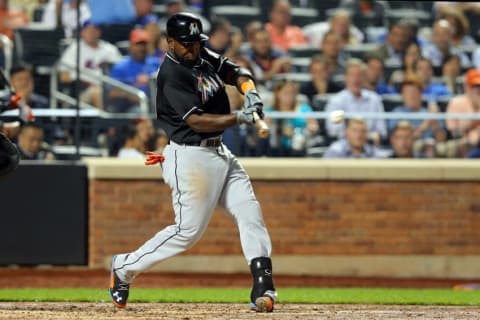 Sep 15, 2015; New York City, NY, USA; Miami Marlins right fielder Marcell Ozuna (13) hits an RBI single against the New York Mets during the fourth inning at Citi Field. Mandatory Credit: Brad Penner-USA TODAY Sports