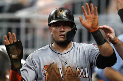 ATLANTA, GA – JULY 31: Miguel Rojas #19 of the Miami Marlns is congratulated in the dugout after scoring in the fourth inning during the game against the Atlanta Braves at SunTrust Park on July 31, 2018 in Atlanta, Georgia. (Photo by Mike Zarrilli/Getty Images)