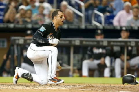 MIAMI, FL – AUGUST 11: Martin Prado #14 of the Miami Marlins reacts after being hit by a pitch from Corey Oswalt #55 of the New York Mets (not pictured) in the sixth inning at Marlins Park on August 11, 2018 in Miami, Florida. (Photo by Michael Reaves/Getty Images)