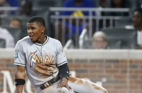 ATLANTA, GA – AUGUST 14: Centerfielder Magneuris Sierra #34 of the Miami Marlins sits on home plate in a cloud of dust after scoring in the sixth inning during the game against the Atlanta Braves at SunTrust Park on August 14, 2018 in Atlanta, Georgia. (Photo by Mike Zarrilli/Getty Images)