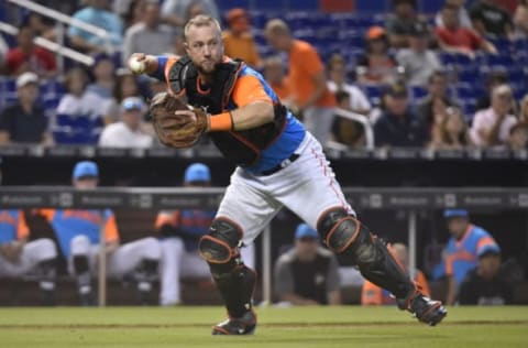 MIAMI, FL – AUGUST 26: Bryan Holaday #28 of the Miami Marlins throws towards first base during the fifth inning against the Atlanta Braves at Marlins Park on August 26, 2018 in Miami, Florida. All players across MLB will wear nicknames on their backs as well as colorful, non-traditional uniforms featuring alternate designs inspired by youth-league uniforms during Players Weekend. (Photo by Eric Espada/Getty Images)