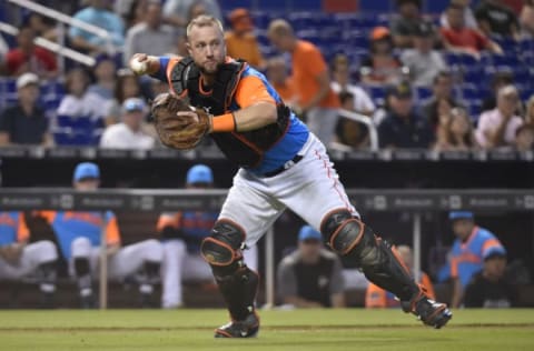 MIAMI, FL – AUGUST 26: Bryan Holaday #28 of the Miami Marlins throws towards first base during the fifth inning against the Atlanta Braves at Marlins Park on August 26, 2018 in Miami, Florida. All players across MLB will wear nicknames on their backs as well as colorful, non-traditional uniforms featuring alternate designs inspired by youth-league uniforms during Players Weekend. (Photo by Eric Espada/Getty Images)