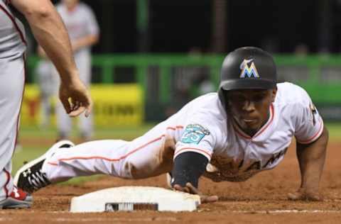 MIAMI, FL – SEPTEMBER 17: Magneuris Sierra #34 of the Miami Marlins dives back towards first base on a pickoff attempt in the sixth inning against the Washington Nationals at Marlins Park on September 17, 2018 in Miami, Florida. (Photo by Eric Espada/Getty Images)