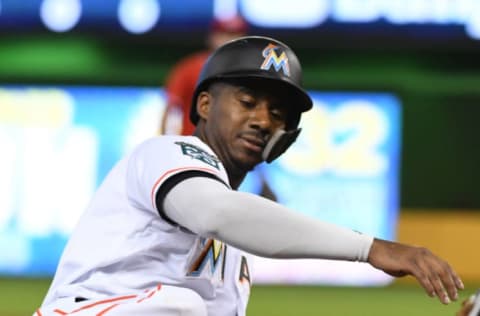 MIAMI, FL – SEPTEMBER 23: Lewis Brinson #9 of the Miami Marlins slides into third base on a force out at third base during the second inning against the Cincinnati Reds at Marlins Park on September 23, 2018 in Miami, Florida. (Photo by Eric Espada/Getty Images)