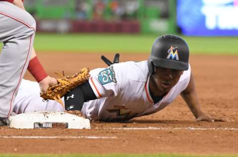 MIAMI, FL – SEPTEMBER 23: Magneuris Sierra #34 of the Miami Marlins dives back into first base on a pickoff attempt during the fourth inning against the Cincinnati Reds at Marlins Park on September 23, 2018 in Miami, Florida. (Photo by Eric Espada/Getty Images)