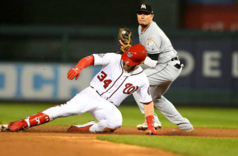 WASHINGTON, DC – SEPTEMBER 24: Bryce Harper #34 of the Washington Nationals slides into second base for a double in the first inning ahead of the throw to Miguel Rojas #19 of the Miami Marlins at Nationals Park on September 24, 2018 in Washington, DC. (Photo by Greg Fiume/Getty Images)