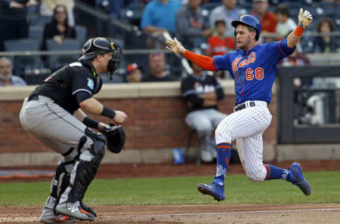 NEW YORK, NY – SEPTEMBER 30: Jeff McNeil #68 of the New York Mets scores a run past Chad Wallach #17 of the Miami Marlins during the fourth inning at Citi Field on September 30, 2018 in the Flushing neighborhood of the Queens borough of New York City. (Photo by Adam Hunger/Getty Images)