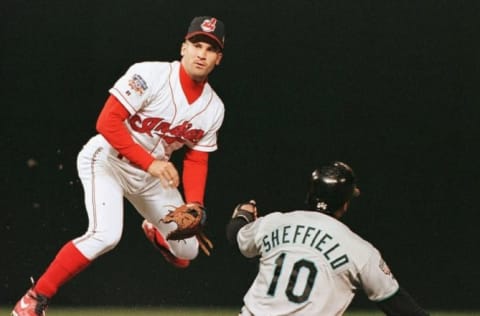 Cleveland Indians shortstop Omar Vizquel (L) completes a double play over Gary Sheffield. JEFF HAYNES/AFP via Getty Images)