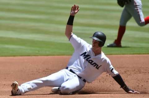 MIAMI, FL – APRIL 21: Brian Anderson #15 of the Miami Marlins slides into third base after a passed ball by Kurt Suzuki #28 of the Washington Nationals during the first inning of the game at Marlins Park on April 21, 2019 in Miami, Florida. (Photo by Eric Espada/Getty Images)