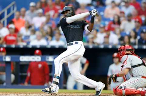 MIAMI, FLORIDA – APRIL 13: Lewis Brinson #9 of the Miami Marlins hits a RBI triple in the second inning against the Philadelphia Phillies at Marlins Park on April 13, 2019 in Miami, Florida. (Photo by Michael Reaves/Getty Images)