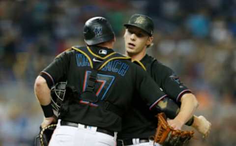 MIAMI, FLORIDA – MAY 18: Adam Conley #61 of the Miami Marlins celebrates with Chad Wallach #17 after defeating the New York Mets 2-0 at Marlins Park on May 18, 2019, in Miami, Florida. (Photo by Michael Reaves/Getty Images)