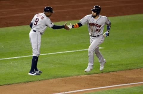 WASHINGTON, DC – OCTOBER 25: Robinson Chirinos #28 of the Houston Astros is congratulated by his third base coach Gary Pettis #8 after hitting a solo home run against the Washington Nationals during the sixth inning in Game Three of the 2019 World Series at Nationals Park on October 25, 2019 in Washington, DC. (Photo by Will Newton/Getty Images)