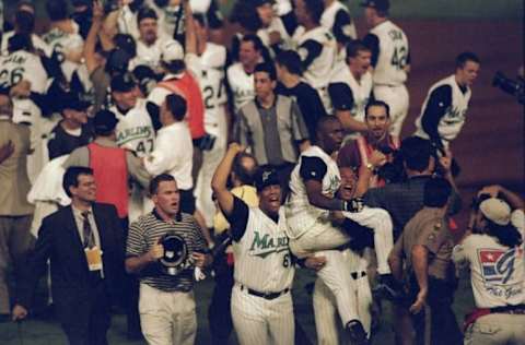 26 Oct 1997: Shortstop Edgar Renteria of the Florida Marlins is carried by teammates outfielder Gary Sheffield and pitcher Livan Hernandez after 11 innings of the 7th game of the 1997 World Series against the Cleveland Indians at Pro Player Stadium in Miami, Florida. The Marlins won the game 3-2 and took the series. Mandatory Credit: Brian Bahr /Allsport