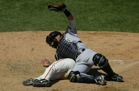 SAN FRANCISCO – AUGUST 23 : Eric Young #21 of the San Francisco Giants slides over home plate into catcher Ivan Rodriguez #7 of the Florida Marlins. (Photo by Justin Sullivan/Getty Images)