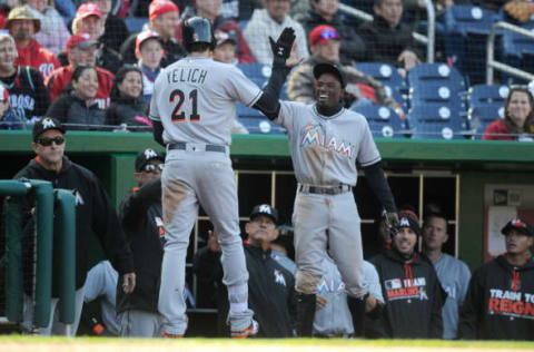 WASHINGTON, DC – APRIL 10: Christian Yelich #21 of the Miami Marlins celebrates with Dee Gordon #9 after hitting a home run in the ninth inning against the Washington Nationals at Nationals Park on April 10, 2016 in Washington, DC. Washington won the game 4-2. (Photo by Greg Fiume/Getty Images)