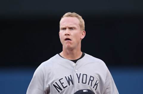 TORONTO, ON – AUGUST 10: Garrett Cooper #64 of the New York Yankees looks on from his position at first base during MLB game action against the Toronto Blue Jays at Rogers Centre on August 10, 2017 in Toronto, Canada. (Photo by Tom Szczerbowski/Getty Images)