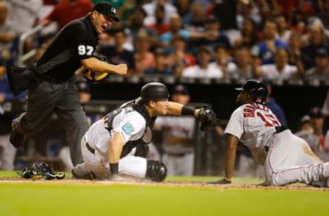 MIAMI, FL – APRIL 03: Umpire Ben May #97 calls Jackie Bradley Jr. #19 of the Boston Red Sox out at home plate after he was tagged by Chad Wallach #17 of the Miami Marlins in the eighth inning at Marlins Park on April 3, 2018 in Miami, Florida. (Photo by Michael Reaves/Getty Images)